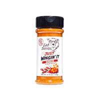 Thumbnail for A bottle of Lab Series Just Wingin' It Barbecue spice blend, featuring orange-red seasoning inside a clear plastic bottle with a black shaker cap and a white label.